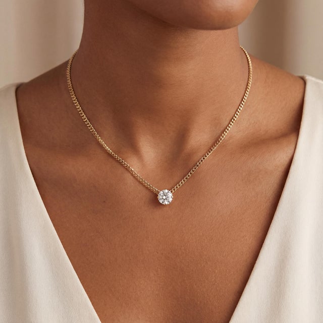 A vintage pendant necklace featuring a 1.28-carat Old European-cut diamond. The diamond is white, with a clarity of VS1...
