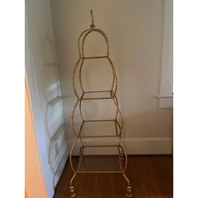 This is a vintage beauty with Hollywood Regency style. The 4 glass shelves are 8” square, 11” square, 14” square and 16.5”...