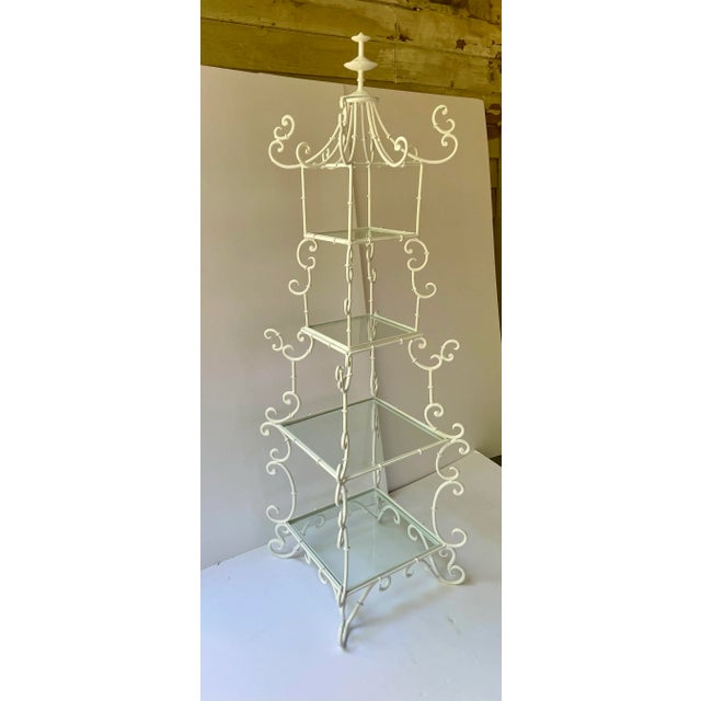 Italian pagoda shaped four tier etagere, constructed of scrolled wrought iron in recent white powder coat finish....