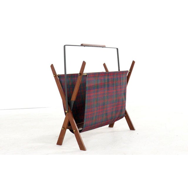 Lovely magazine rack with a teak frame and a holder in atmospheric fabric. Cool and typical Danish design with warm-...
