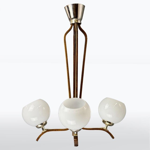 This elegant pendant light from the 1970s features a distinctive design that combines wood, metal, and glass. Its three...