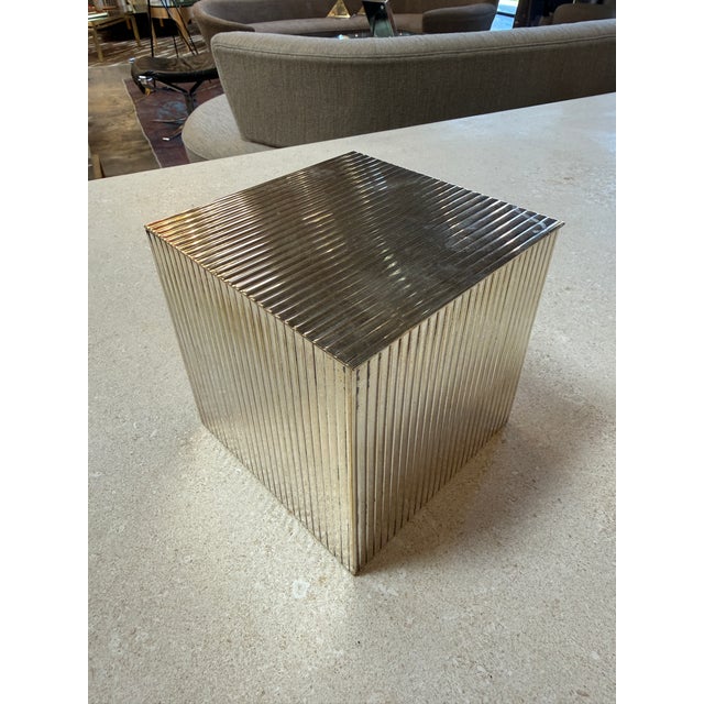 Striking vintage storage box crafted in brass with a distinctive ribbed exterior design and a sleek hinged lid. The...