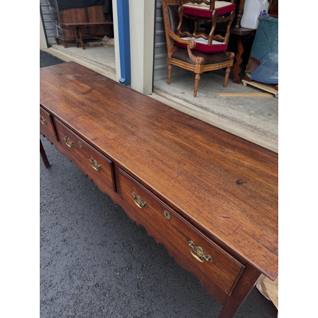 Own a piece of history with this 18th Century English Welsh Dresser Base. Crafted with timeless charm, this antique...