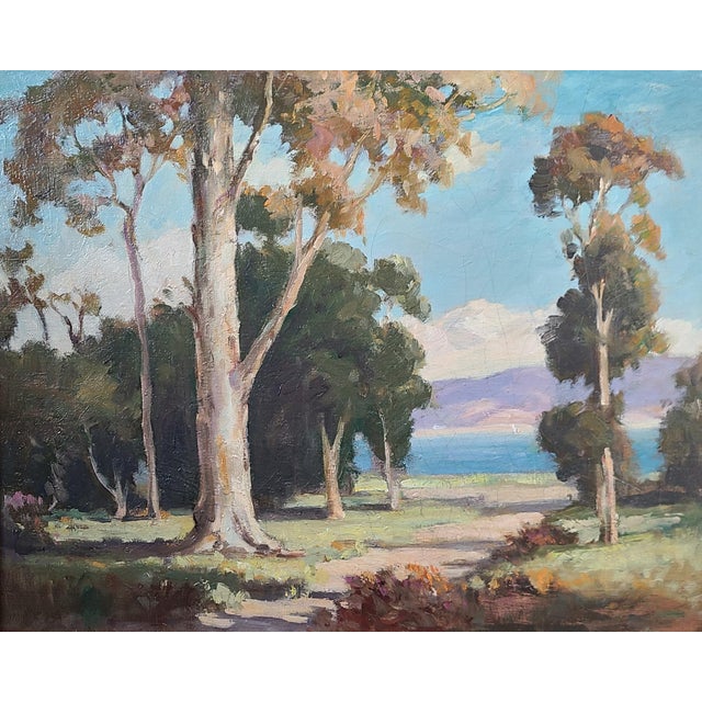 Stunning 1950s oil painting depicting a view of the California coast perfectly framed by a cluster eucalyptus trees. The...