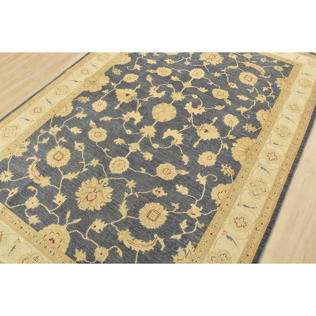 A traditional Ziegler rug hand-knotted with fine wool on a cotton foundation. This rug features a botanical design set...