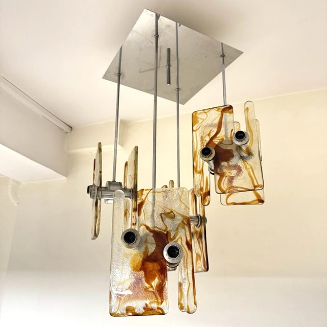 This impressive and spectacular chandelier, a highly collectible piece dating back to the 1970s, features a modernist,...