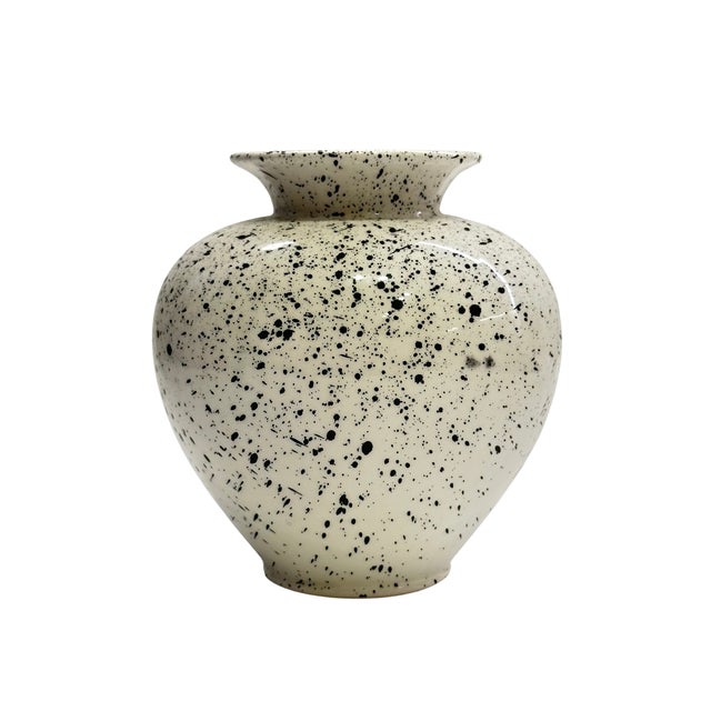 A striking vintage Italian ceramic vase featuring a creamy ivory ground covered in an expressive black splatter glaze. The...