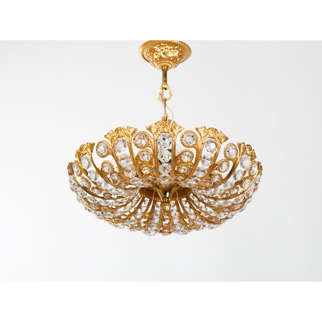 Vintage 4-light ceiling pendant lamp consisting of brass segments encrusted with crystal glass varying in size. All parts...