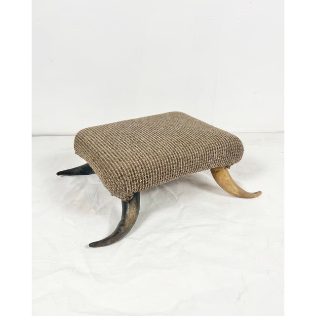 Vintage horn leg ottoman/footstool. Small foot stool perfect to rest your feet on. Curved horn legs with upholstered top.