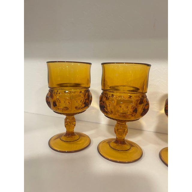 This lovely set of rich looking amber wine glasses are vintage Indiana Glass King's Crown wine goblets featuring a...
