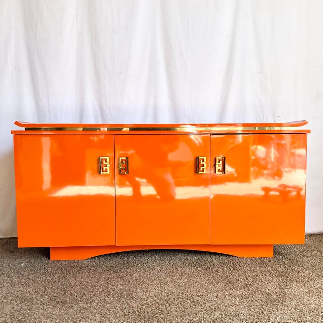 This striking postmodern credenza features a high-gloss orange laminate finish paired with elegant chinoiserie-inspired...