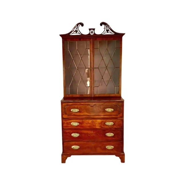 Early 19th Century George III Mahogany Secretaire Bookcase. Bookcase features a broken swan-neck pediment with fretwork...