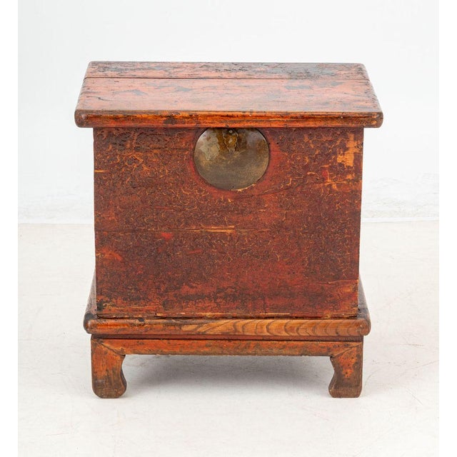 Chinese Red Painted Elm Chest, the removable top opening to storage compartment. 23" H x 22.25" W x 17" D. Provenance:...