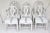 A set of six mid 19th century Swedish dining chairs in the classic oval back Gustavian style with bold carved rose crest...