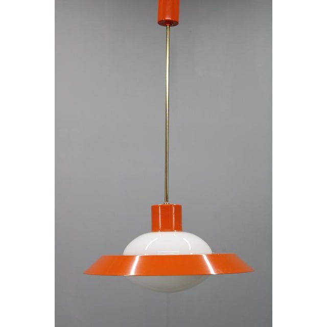 This Mid-Century Modern pendant lamp was produced in Czechoslovakia in the 1970s, originating from the historic...