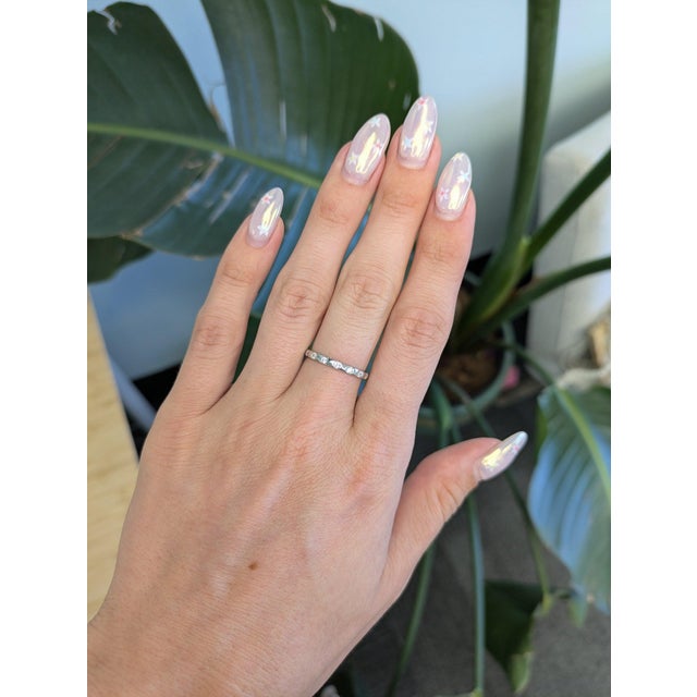 A continuous line of natural diamonds brings quiet brilliance to this slender band, hand-set in solid 14K white gold....
