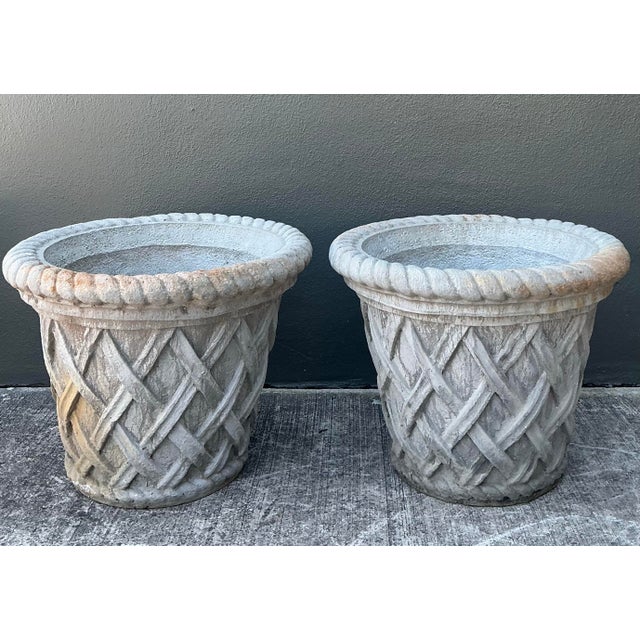 This striking pair of vintage cast concrete planters offers a timeless blend of French Country charm and coastal elegance....