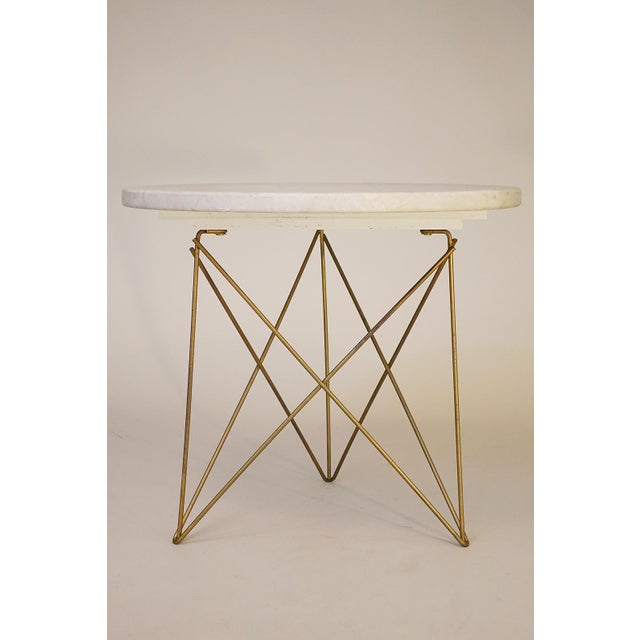 A very modern and minimalistic styled Travertine Marble side table with original Eames style wire "Eiffel" tripod base....