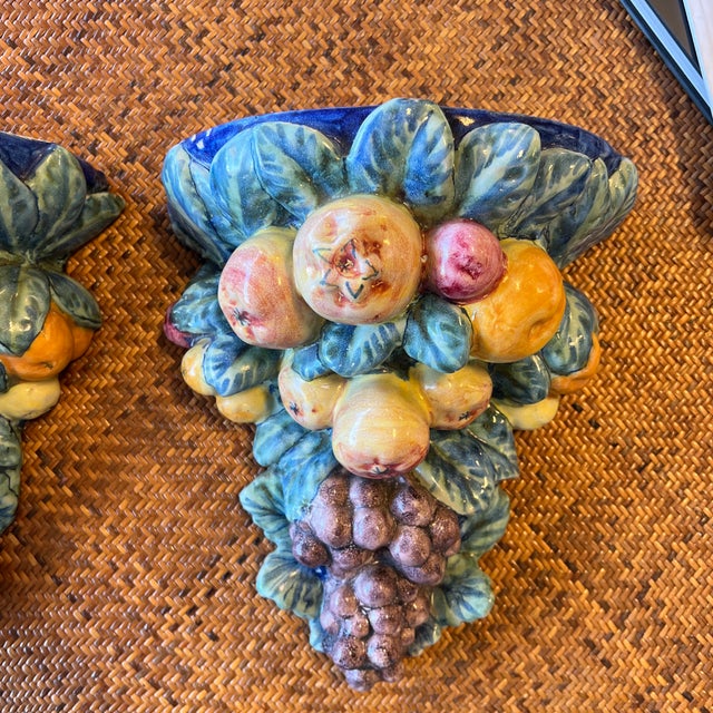 Fabulous vintage set of ceramic wall brackets. Very colorful and beautifully made. Adorned with grapes and fruits, these...