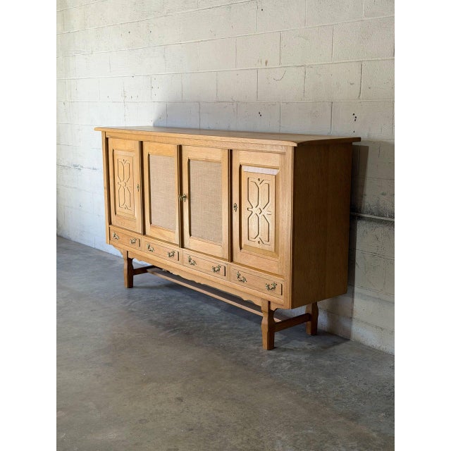 This striking sideboard features four doors and four base drawers for expansive storage. The facade highlights geometric...