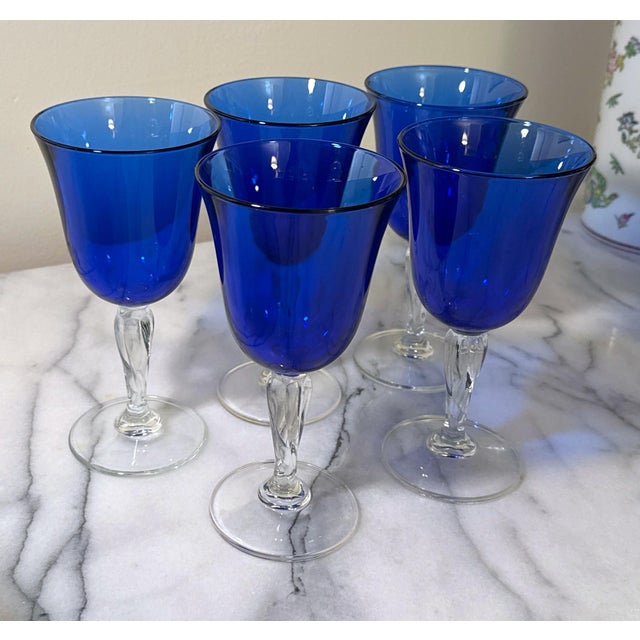 Five (5) stunning cobalt blue crystal water / wine goblets. They add a pop of color to any collection. These glasses are...