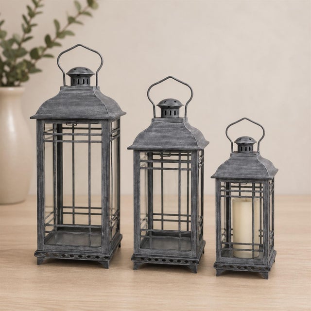 Elevate your home decor with this stunning set of traditional grey metal lanterns. Featuring a weathered, rustic finish,...