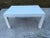 Mid-Century Modern white laminate parsons table. Sleek modern design, quality white laminate exterior over plywood base....