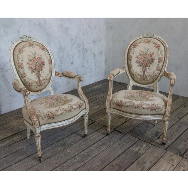 An exquisite pair of French Louis XVI style armchairs. Elevate your décor to the heights of luxury and elegance with this...