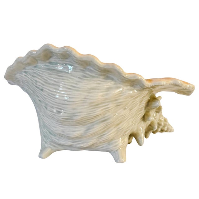 A sculptural vintage ceramic and beautifully detailed conch shell vessel. Features a deeply textured, ribbed exterior...
