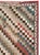 This mid-20th-century Turkish Anatolian square carpet presents a lively checkerboard field arranged in sweeping diagonal...
