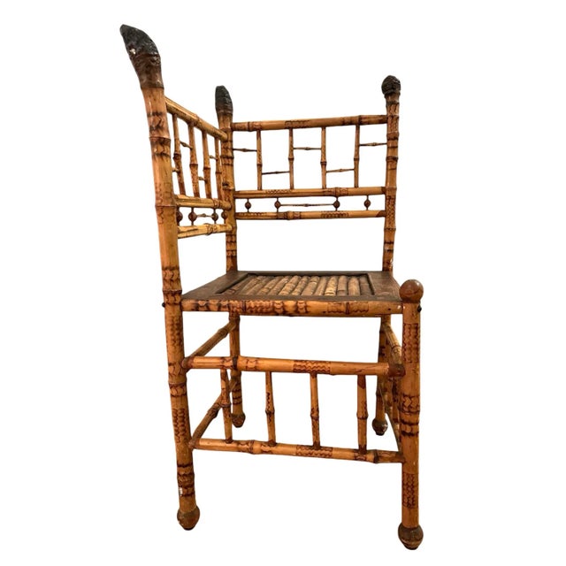 Antique English tortoise bamboo corner chair. Stick and ball detailing on back.