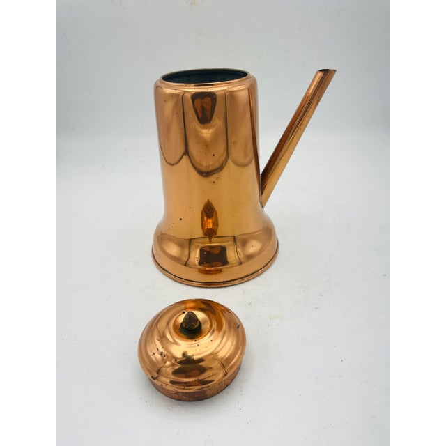 Coppered Turkish Style Teapot. The teapot features a wooden handle with a brass knob and brass side escutcheon. The teapot...