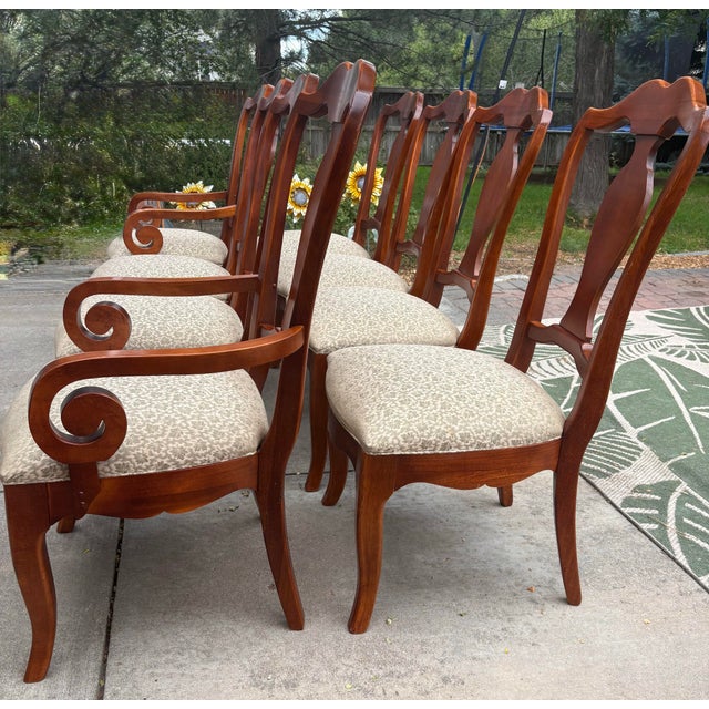 Elegant set of eight vintage Thomasville dining chairs featuring six side chairs and two coordinating armchairs in a warm...