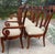 Elegant set of eight vintage Thomasville dining chairs featuring six side chairs and two coordinating armchairs in a warm...