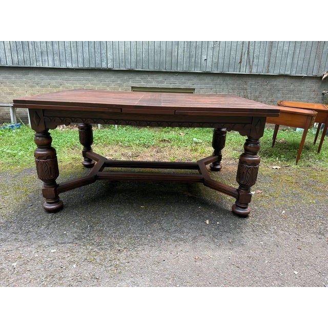 Early 20th Century Antique Jacobean Style Carved Oak Draw Leaf Dining Table .Jacobean revival style, featuring a stretcher...