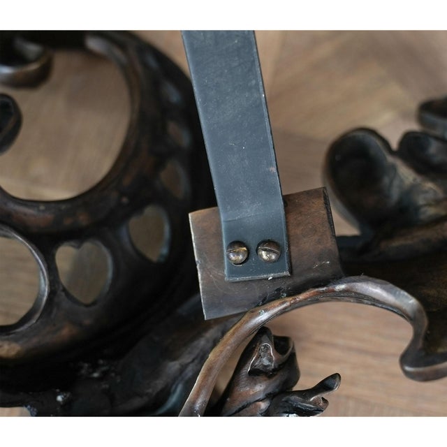 From Niagara Furniture a Single Female Bronze And Iron, Fireplace Decoration. Completely hand cast using traditional lost...
