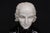 Sculptural bust of Wolfgang Amadeus Mozart, crafted in contrasting white, black, and peach-toned marble. The portrait...