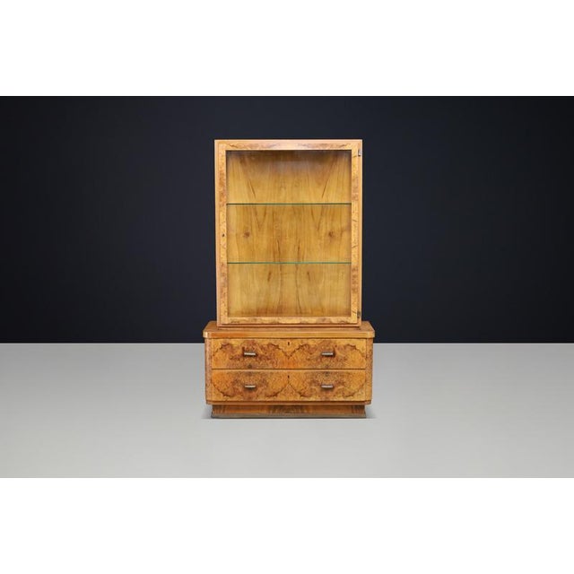 Exceptional Parisian Art Deco display cabinet from the 1930s, executed in richly figured burl walnut and fitted with...