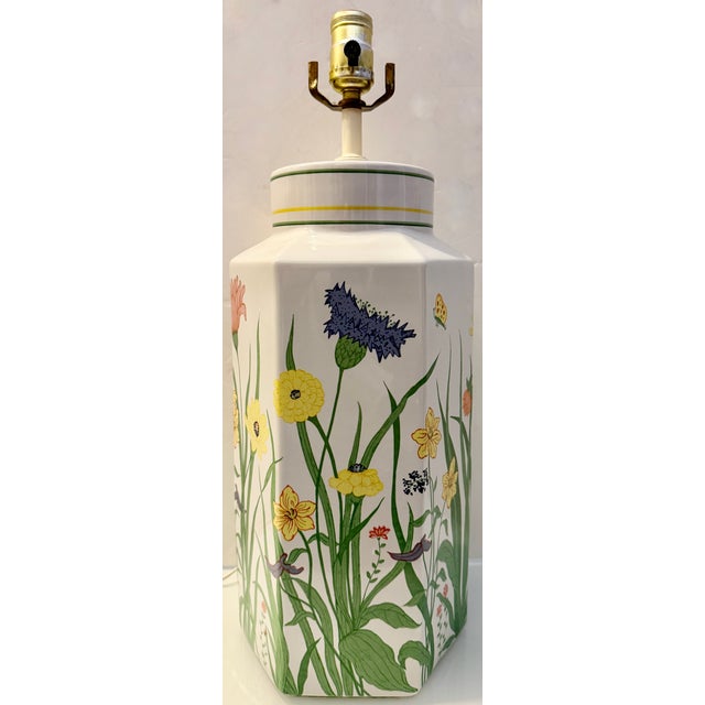 1970's hexagonal ceramic table lamp with a multi-color wildflower or botanical design. It is often described as having a...