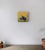 The artwork features a rhinoceros adorned in a tailored outfit, set against a warm, golden background that evokes a sense...