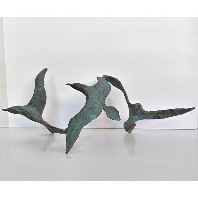 Vintage patinated cast iron sculpture of three birds in flight. Suitable for wall (with hanging hook) or standing on its...