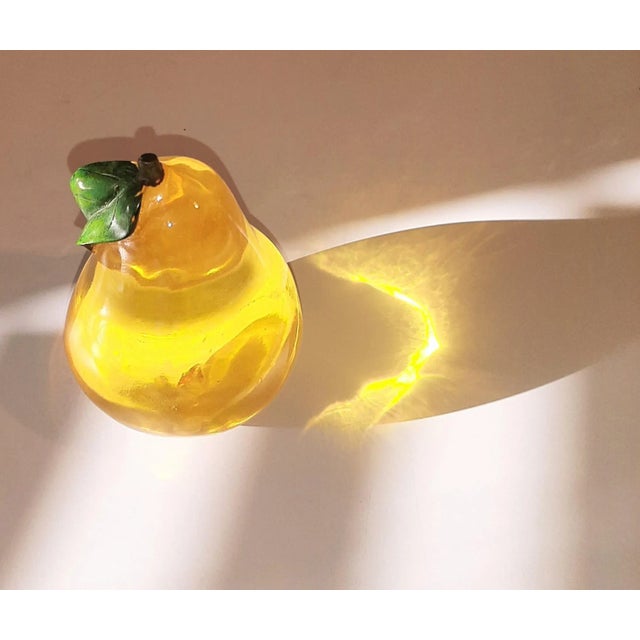 Solid yellow gold lucite pear. Catches the light so beautifully. Mid Century plus Holleywood regency decor.