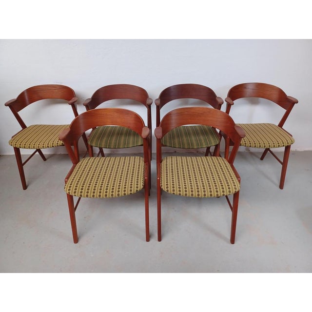 Six Danish teak dining chairs with upholstery of hand made cross stitch embrodery The set of dining chairs in teak...