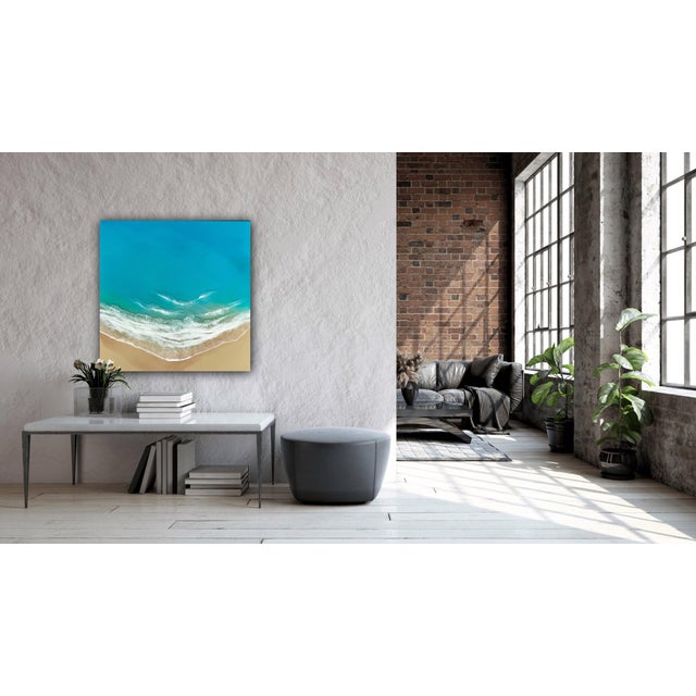 This artwork depicts a serene beach scene, where vibrant turquoise waters meet soft sandy shores. The layered tinted resin...