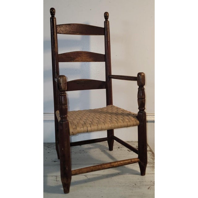 19thc childs wooden ladder back chair with cane seating. Wonderful dark brown patina color. This childs chair is strong...