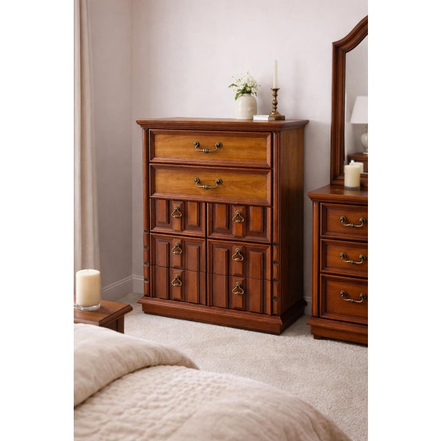 A beautifully preserved 1970s traditional revival five-drawer chest in a rich brown mahogany finish, featuring framed...