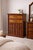 A beautifully preserved 1970s traditional revival five-drawer chest in a rich brown mahogany finish, featuring framed...