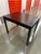 Dunbar side table in dark finish with brass stretcher detail