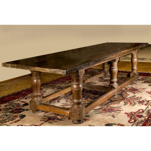 This charming 17th Century massive scale rectangular refectory table, dating back to Baroque period, is a magnificent...
