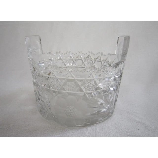 50's era Polish cut crystal basket with incredible detail of flowers on all sides. It measures 5.5"H x 6.75"D and is in...